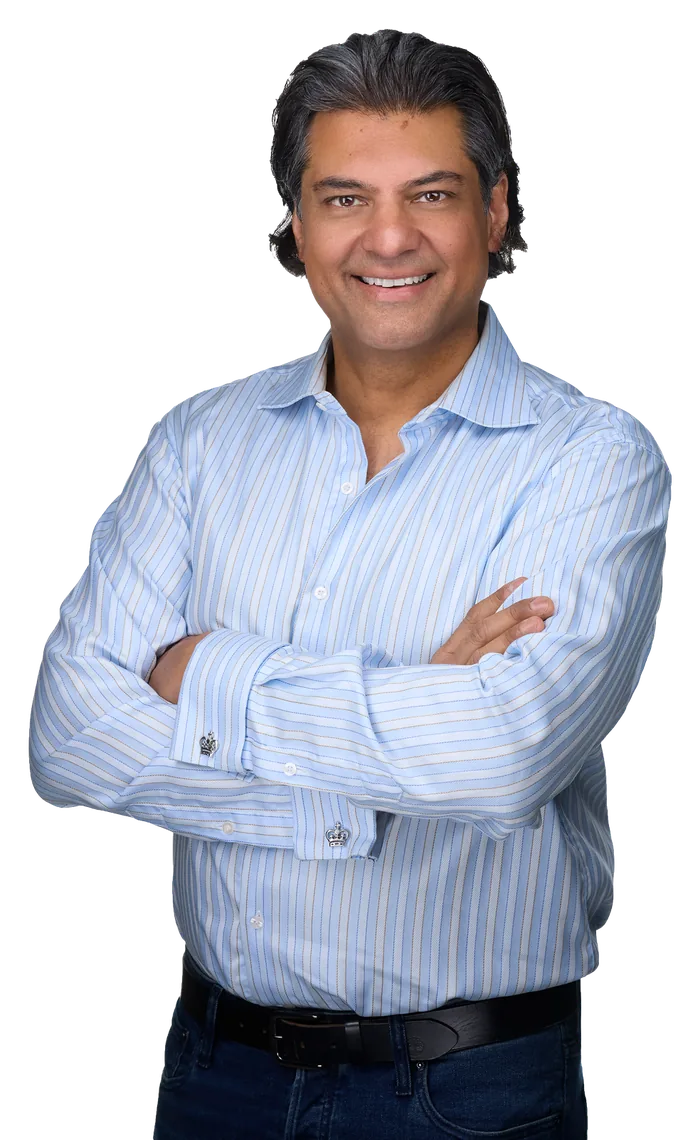 Rahim Jaffer smiling, arms crossed, in a blue striped shirt